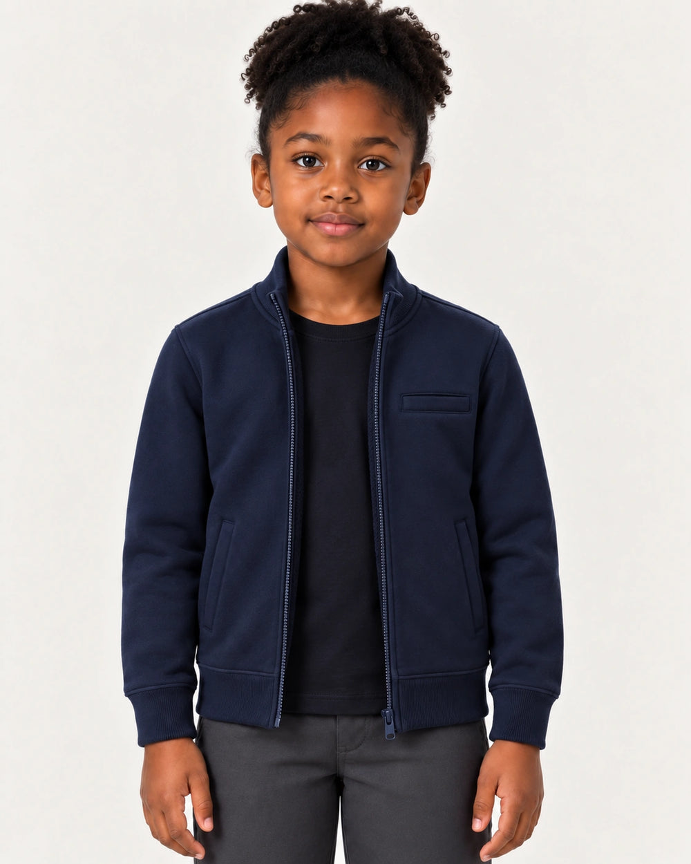 Girl wearing the Aombe Girls' Sweat Jacket in navy blue with both hands in the slash side pockets