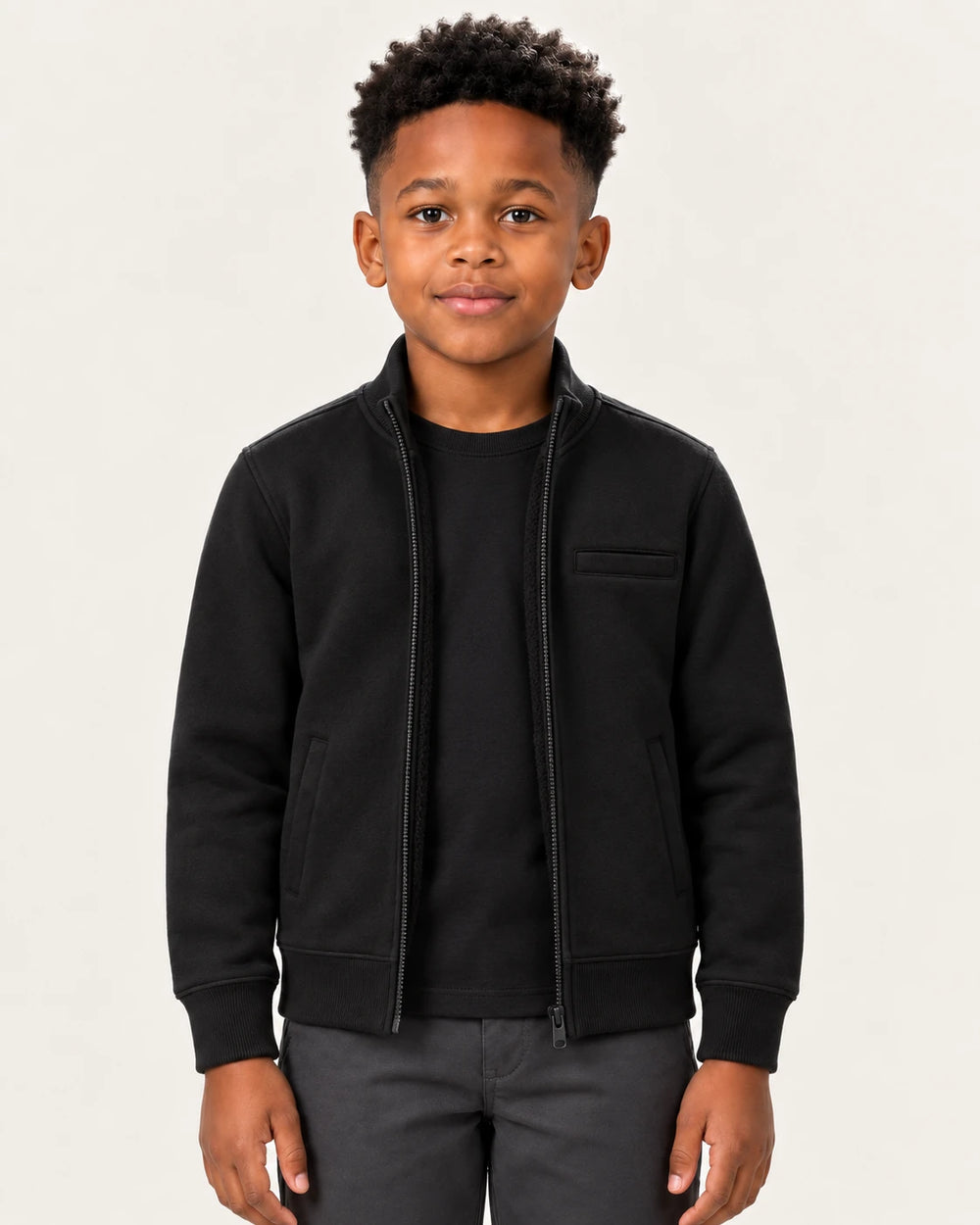 Boy wearing the Aombe Boys' Sweat Jacket in black, front view with the zip open over a plain tee
