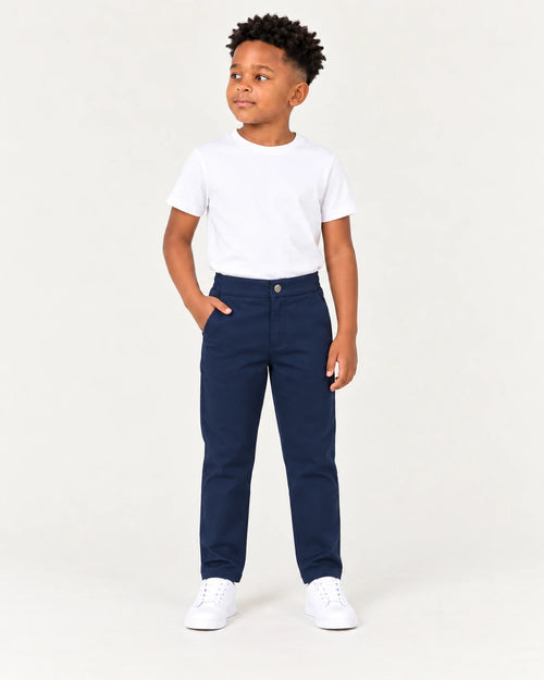 Aombe boys' navy chino pants worn full-body front view with a tucked white T-shirt and white sneakers