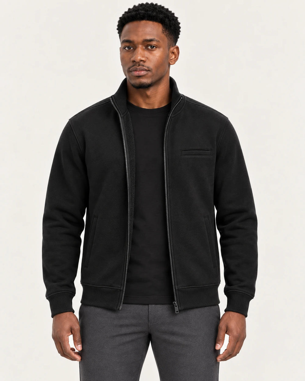Man wearing the Aombe Men's Sweat Jacket in black, front view with the zip open over a plain tee