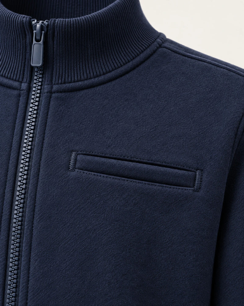 Close-up of the welt chest pocket on the navy Aombe Sweat Jacket, showing bar tacks and topstitching